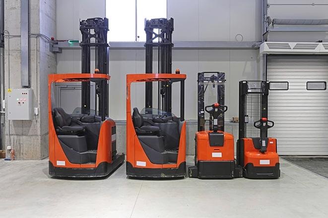 forklifts in a warehouse moving heavy pallets